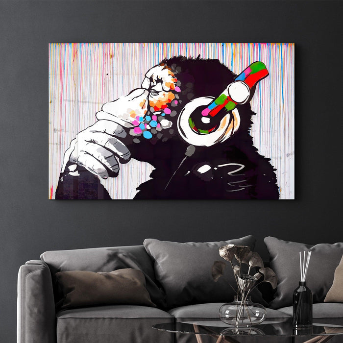 Banksy Monkey Beat glass wall art by Artdesigna featuring a striking image of a monkey on transparent glass.