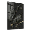 Elegant black and gold feather glass wall art by Artdesigna, showcasing intricate details and vibrant colors on a sleek wall surface.