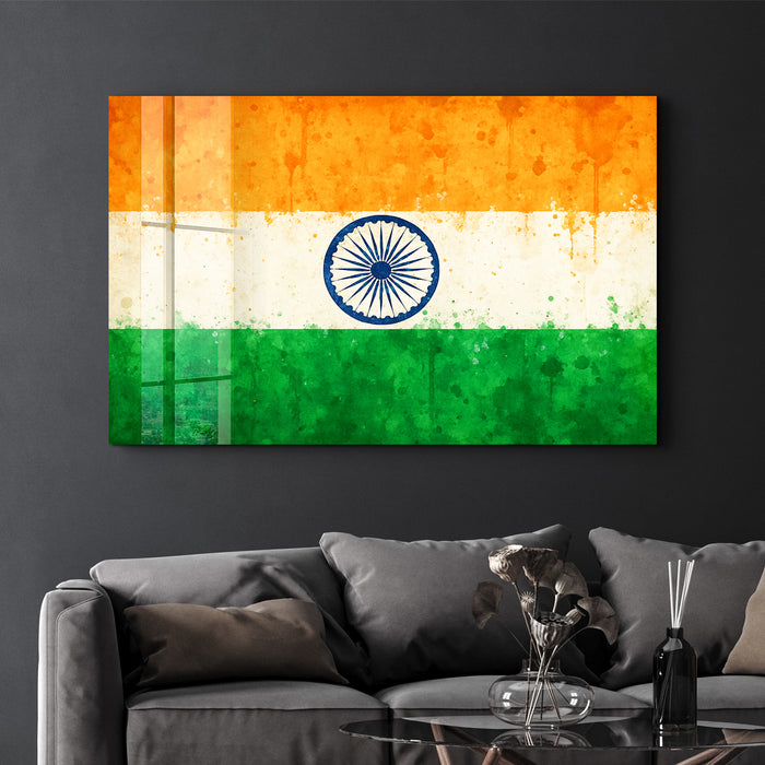 Glass wall art featuring a vibrant India flag splash design by Artdesigna, 16x10 inches, suitable for wall decoration.
