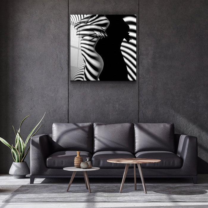 Elegant glass wall art piece by Artdesigna titled Naked Shadows, featuring abstract shadow-inspired designs on clear glass.