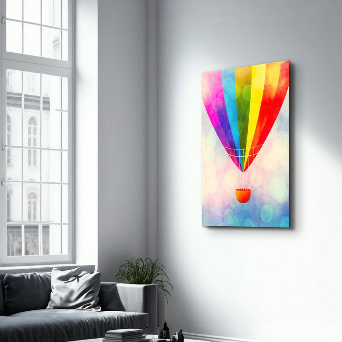 Colorful glass wall art featuring a vibrant hot air balloon design by Artdesigna, displayed on a wall in a modern interior setting.